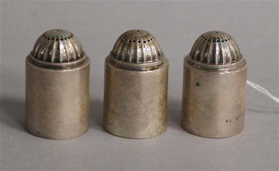 A set of three early 20th century Georg Jensen Danish sterling silver pepperettes, no.627, import marks for London, 1931, 39mm.